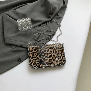 Detail of leopard print crossbody bag with silver bead trim and metallic chain strap