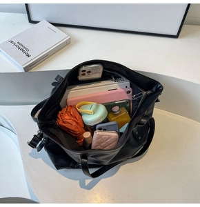 Interior view of black pebbled leather tote bag showing large capacity for daily items