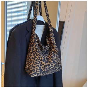 Detail of trendy leopard print canvas tote bag on a hanger for stylish commuting