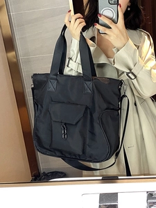 Black large capacity waterproof nylon tote bag with adjustable shoulder strap and metal buckle
