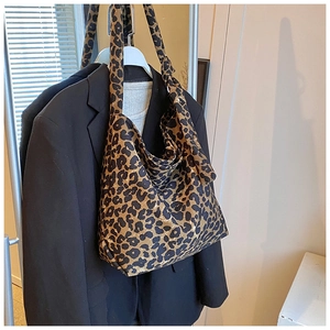 Detail of trendy leopard print canvas tote bag with wide strap for daily wear