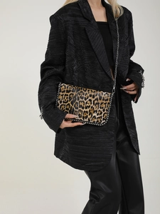 Detail of leopard print crossbody bag with silver chain strap and metal stud trim
