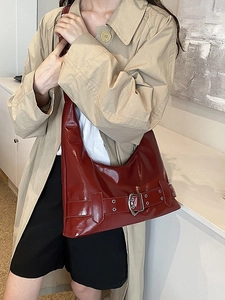 Chic burgundy patent leather underarm shoulder bag for women in a stylish urban setting