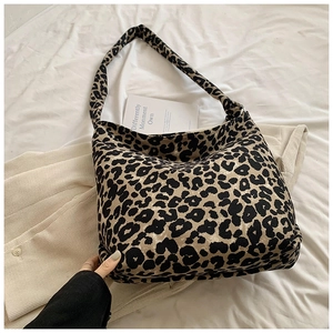 Detail of trendy leopard print canvas tote bag featuring large capacity and wide straps