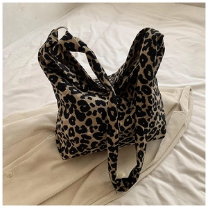 Close-up of leopard print canvas tote bag with stylish wide knotted shoulder strap detail