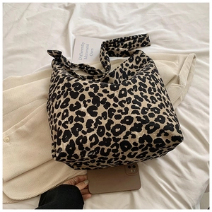 Close-up of leopard print canvas tote bag showing thick texture and stylish wide shoulder strap