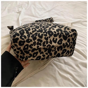 Close-up of leopard print canvas tote bag featuring stylish decorative knot handle design