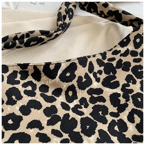 Close-up of stylish leopard print canvas tote bag with detailed fabric texture and stitching