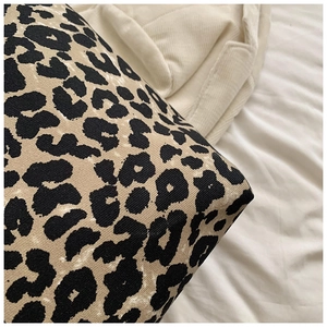 Close-up of leopard print canvas tote bag showing high-quality stitching and fabric texture