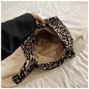 Interior detail of leopard print tote bag showing khaki lining and inner zipper pocket