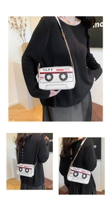 Detail view of retro cassette tape shaped shoulder bag with golden chain strap