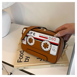 Detailed view of the creative retro cassette-shaped shoulder bag with golden chain
