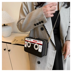 Fashionable cassette-shaped crossbody bag with a vintage tape design and golden metal chain