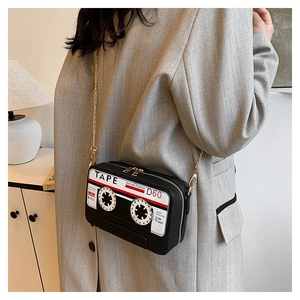 Close-up of retro cassette tape shaped PU leather crossbody bag with golden chain strap