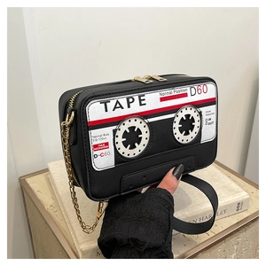 Macro shot of unique cassette tape bag featuring vintage red and white finish and chain strap