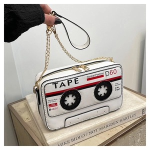 Detailed view of creative cassette tape shoulder bag with white PU leather and golden chain