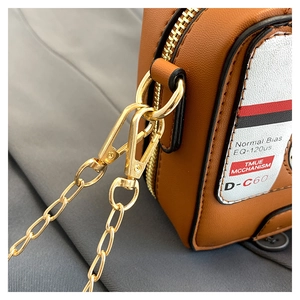 Detail of vintage cassette tape crossbody bag with gold chain and zipper closure