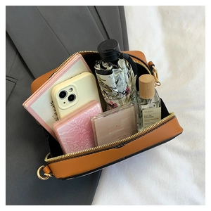 Internal storage of the vintage cassette crossbody bag with daily essentials shown