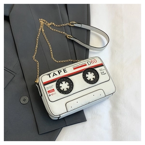 Detail of creative vintage cassette tape crossbody bag with a gold chain strap