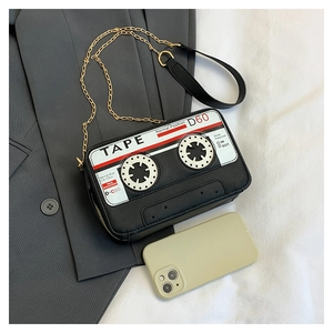 Detailed view of the cassette-shaped crossbody bag with gold chain and size comparison