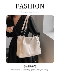 Detailed close-up of cream white PU leather tote bag with geometric stitching texture