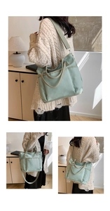 Detail view of light green canvas tote bag with thick texture and dual strap design