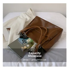 Detail presentation showing the spacious interior of the brown leather tote bag