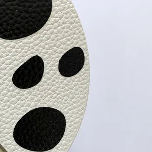 Close-up of premium white litchi grain texture with black polka dots on kids' shoulder bag