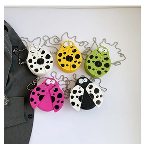 Detail of mini ladybug-shaped crossbody bags in multiple colors with silver chain straps