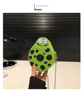 Detail of green ladybug mini crossbody bag with litchi grain PU leather and bead chain