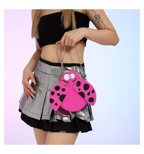 Detail of ladybug shaped pink faux leather mini bag with silver bead metal chain