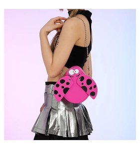 Detail view of ladybug-shaped pink PU crossbody bag with cartoon eyes and chain strap