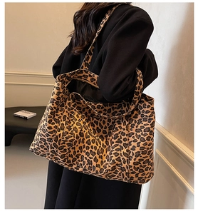Macro shot of large leopard print tote bag interior featuring black lining and zipper pocket