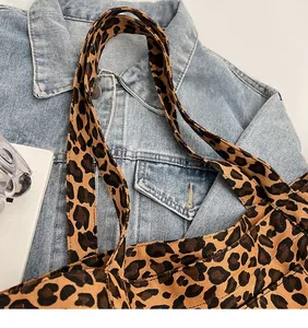 Detailed view of the leopard print tote bag canvas material and sturdy shoulder straps