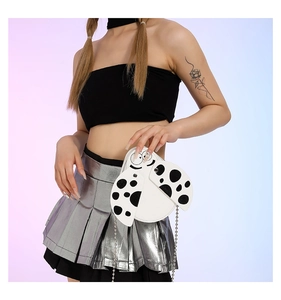 Girl's ladybug crossbody bag with black dots and silver chain strap on model