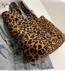 Detailed view of the leopard print canvas tote bag texture and durable shoulder strap