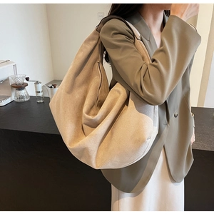 Minimalist light camel suede hobo bag with large capacity shown in a lifestyle setting
