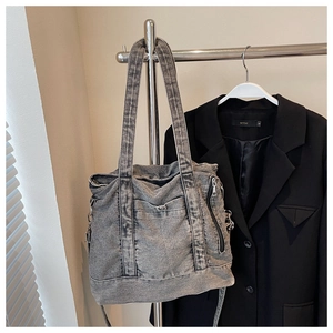 Detailed close-up of retro washed grey denim tote bag hanging on a stylish metal hanger