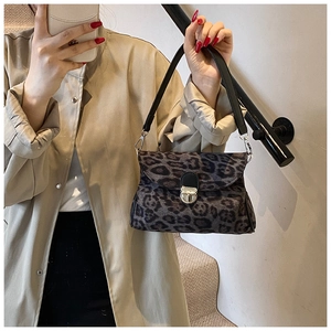 Detail showing vintage leopard print shoulder bag with silver buckle and black strap
