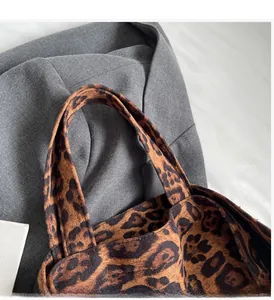 Close-up of leopard print tote bag handle with high-quality reinforced stitching details