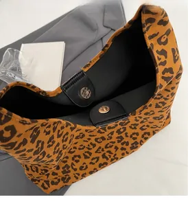 Détail d'un sac cabas léopard avec fermoir magnétique et finitions dorées chic