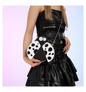 Detail of ladybug cross-body bag with ladybug spots and silver metal chain strap