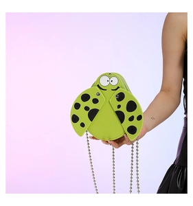 Detail of green insect mini bag showing textured faux leather and metal chain