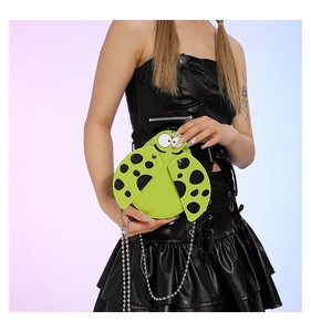 Detail of ladybug shaped green mini PU shoulder bag with chain strap and cartoon dots