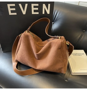 Detail of caramel brown suede texture on a vintage minimalist baguette shoulder bag