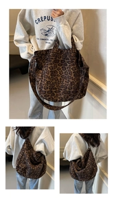 Detail view of a large leopard print tote bag with dual straps in a soft canvas material