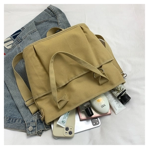 Top view of spacious canvas tote bag interior showing daily items like a tablet and umbrella