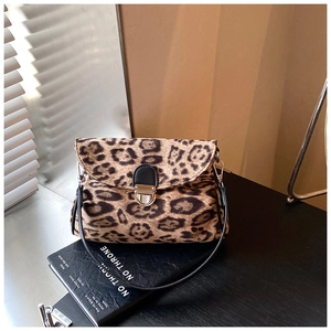 Close-up of leopard print shoulder bag featuring silver metal lock and black strap detail