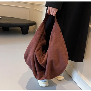 Close-up of large capacity suede tote bag showing soft matte texture and inner zipper pocket