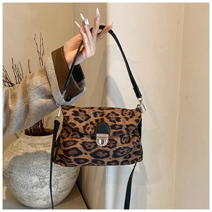 Detail of leopard print handbag featuring a silver buckle and detachable black strap